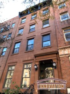 Close-up of repaired brownstone cornice on East Village building
