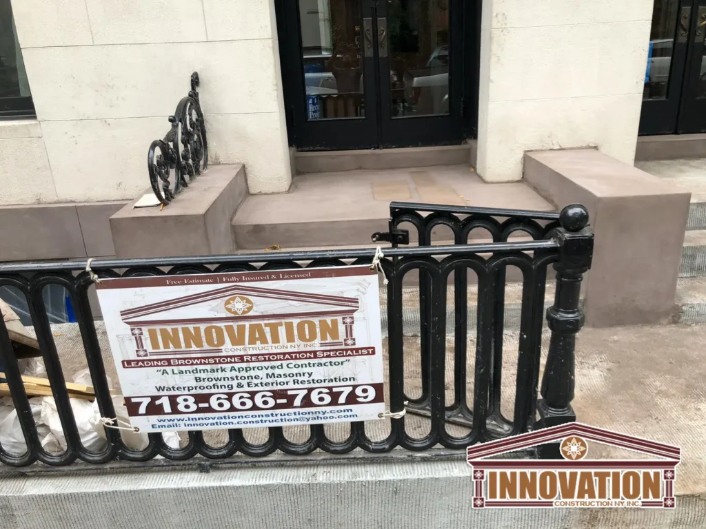 Workers restoring stoop details at a Brooklyn brownstone