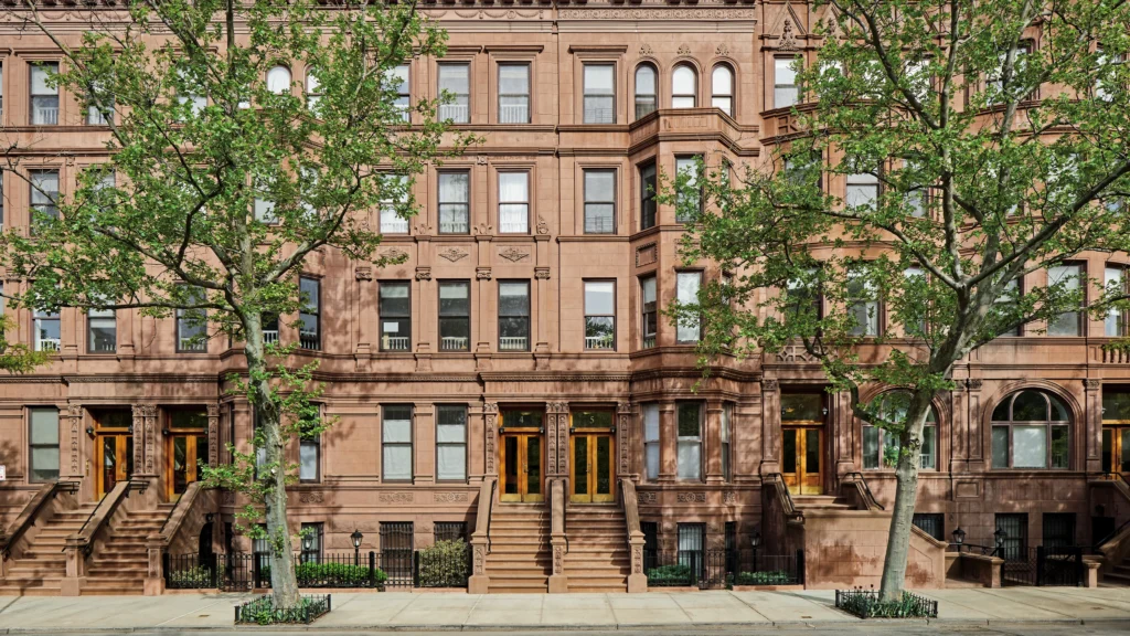 Historic New York brownstone with classic stoop, elegant windows, and detailed façade in a Manhattan neighborhood