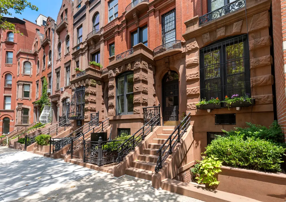 Manhattan brownstones featuring historic façades, decorative cornices, and urban streetscape