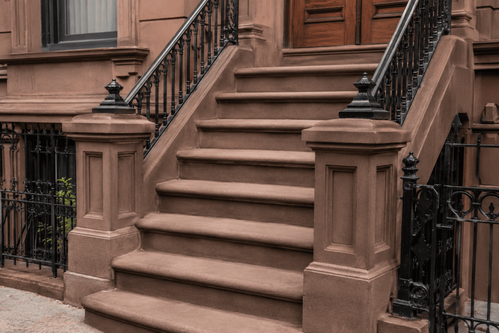 Brownstone Stoop Restoration NYC with restored stone steps and cast iron railings on a historic Brooklyn brownstone
